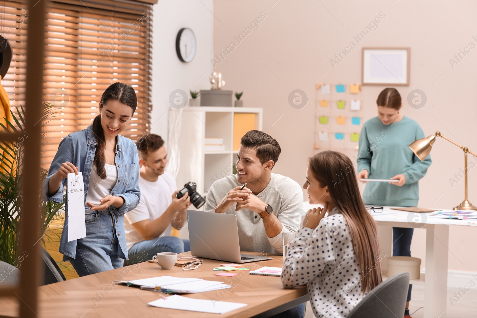 Photo of Team of professional journalists working in office