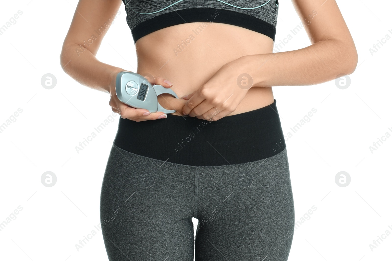 Photo of Young woman measuring body fat with caliper on white background, closeup