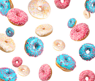 Set of falling delicious donuts on white background