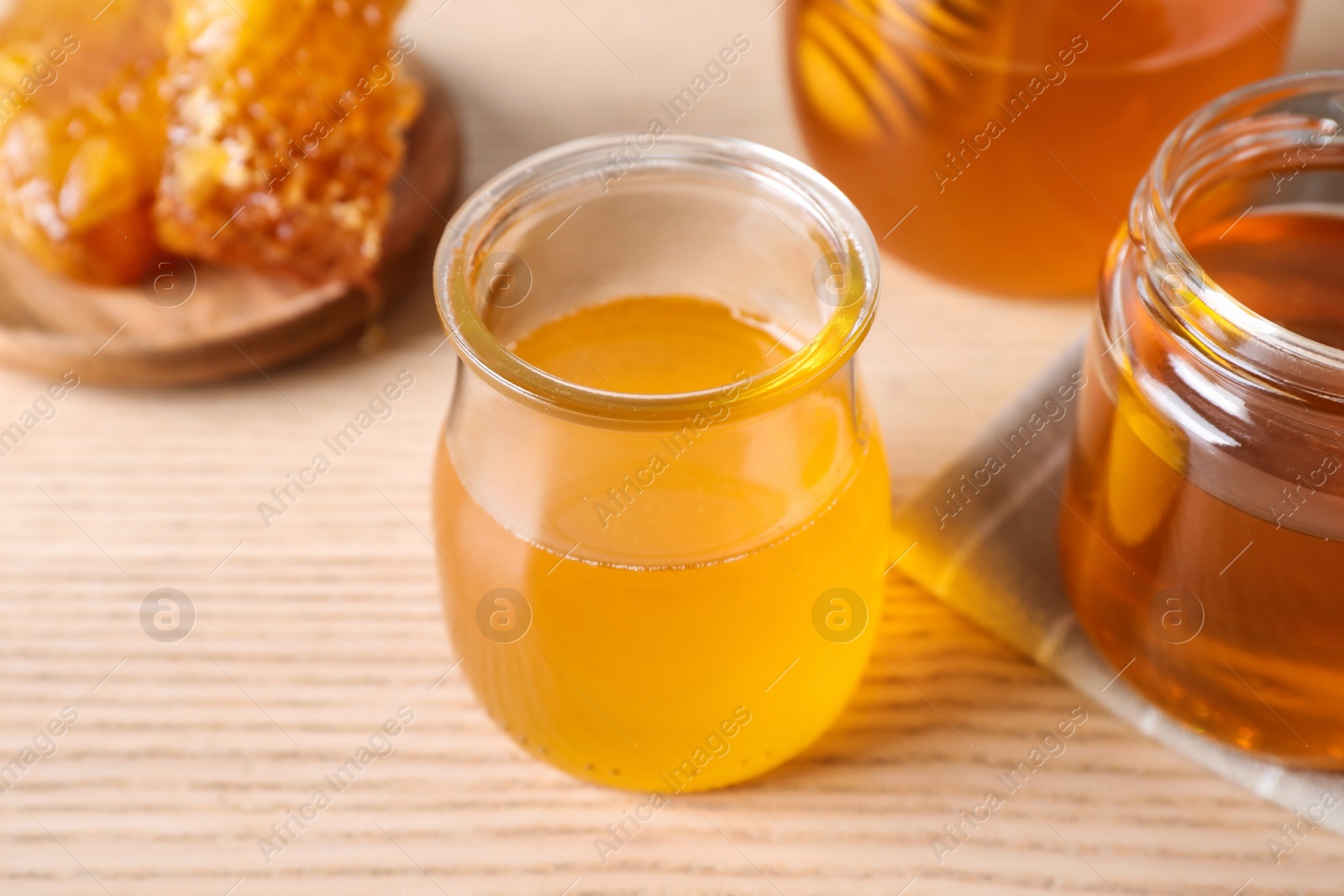 Photo of Tasty fresh organic honey on wooden table