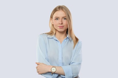 Portrait of beautiful young woman in stylish blouse on white background