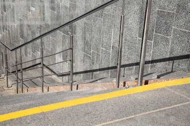 Ramp with metal handrail near building outdoors