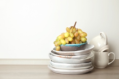 Photo of Composition with dinnerware on table against light background, space for text. Interior element