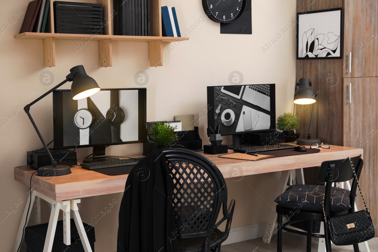 Photo of Stylish workplace interior with computers on table