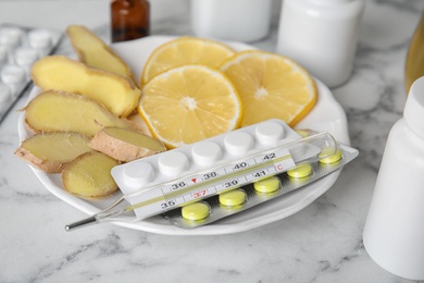 Photo of Different cold remedies on white marble table