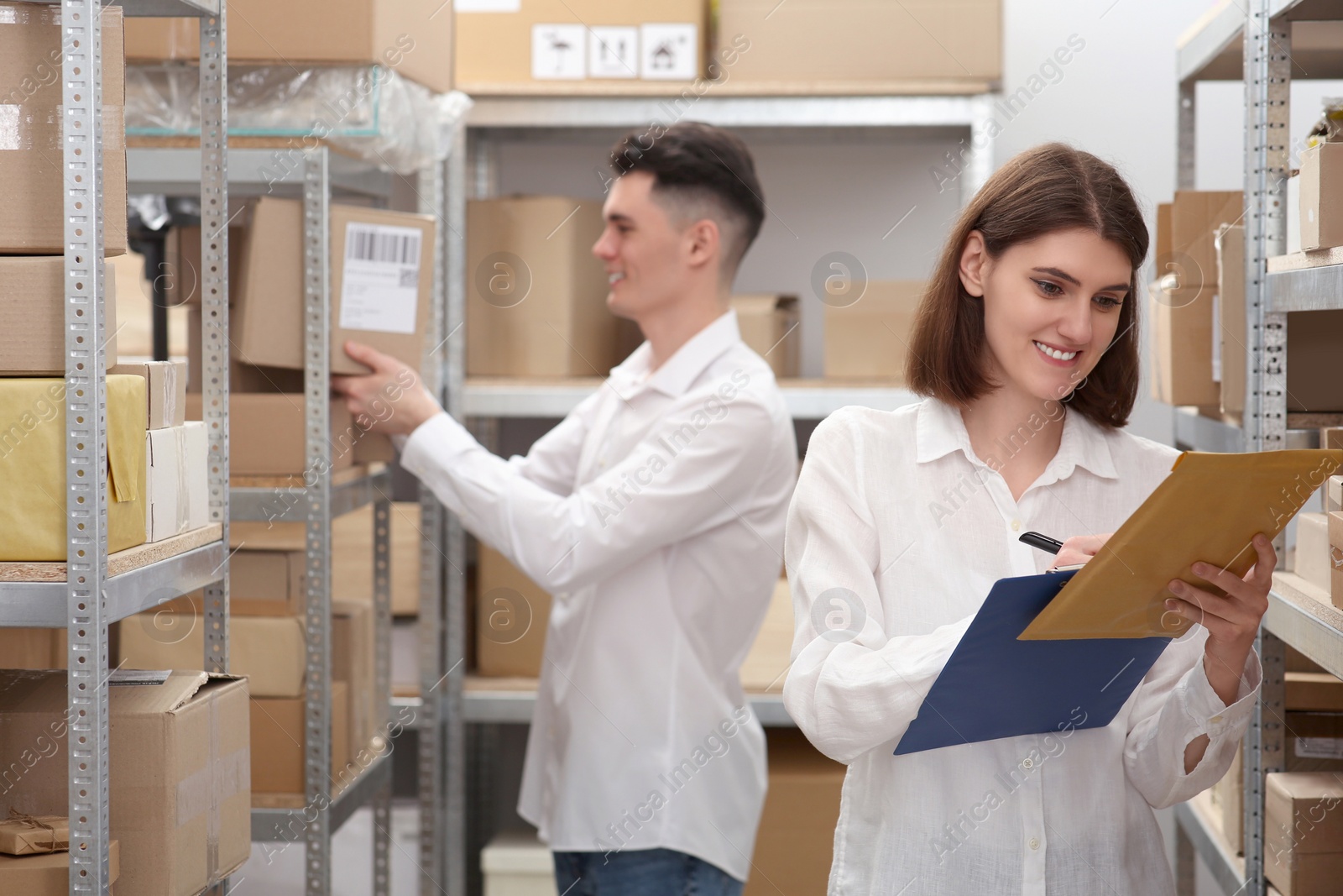 Photo of Young post office employees working in warehouse