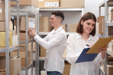 Photo of Young post office employees working in warehouse