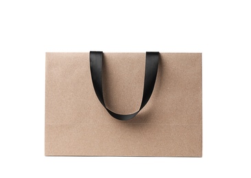 Paper shopping bag with ribbon handles on white background. Mockup for design