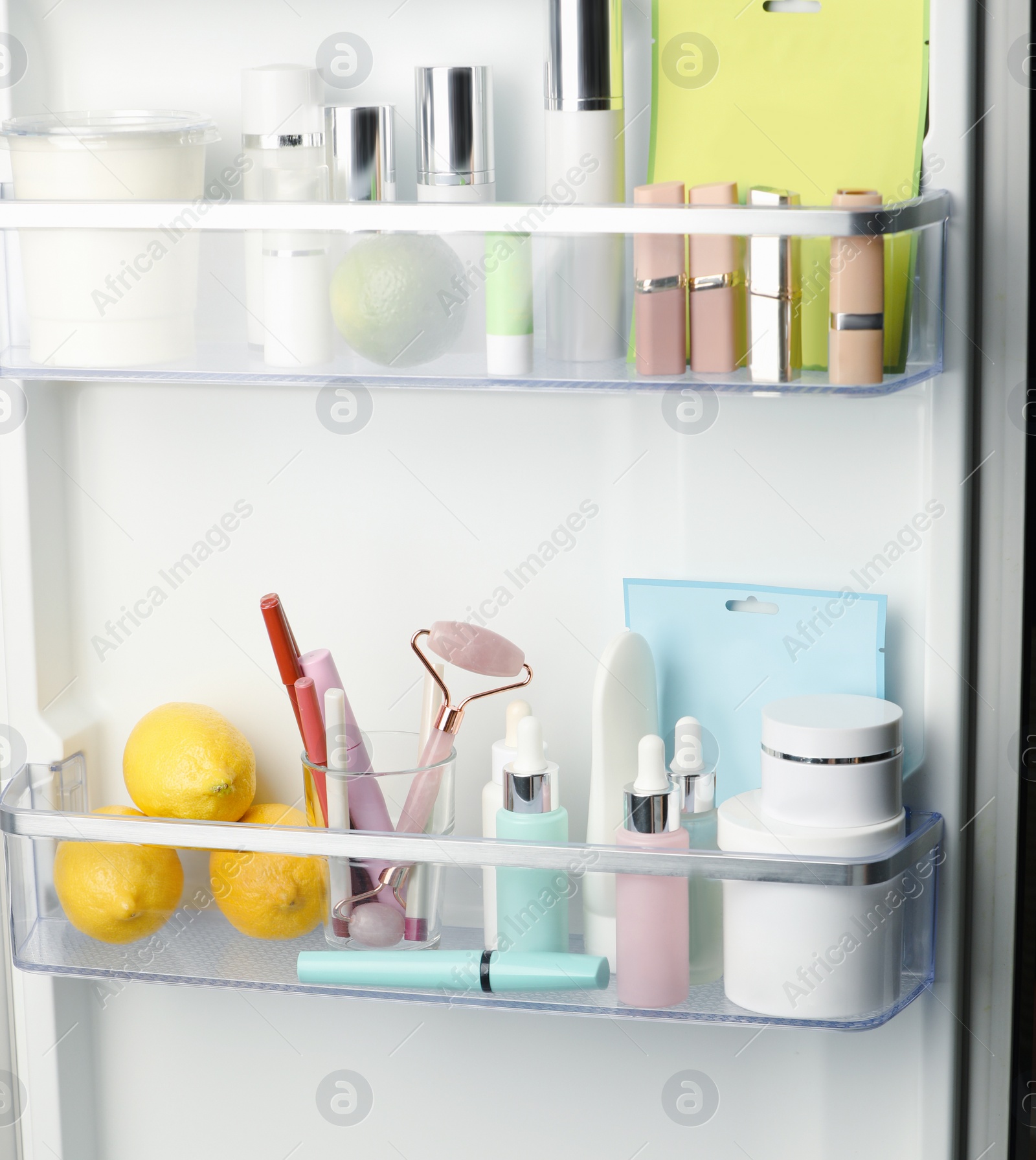 Photo of Different cosmetic products on shelves in refrigerator