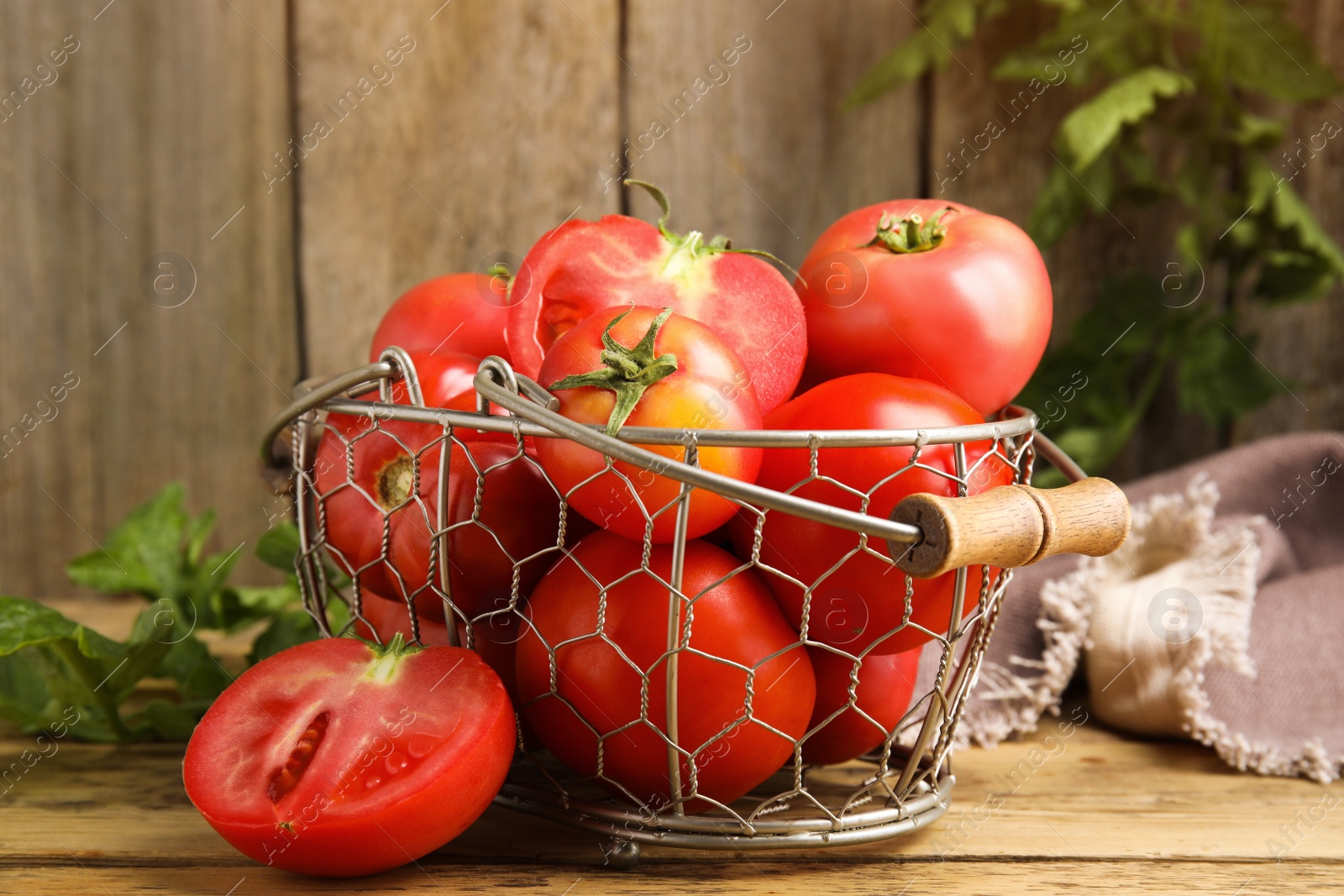 Photo of Fresh ripe tomatoes with leaves on wooden table