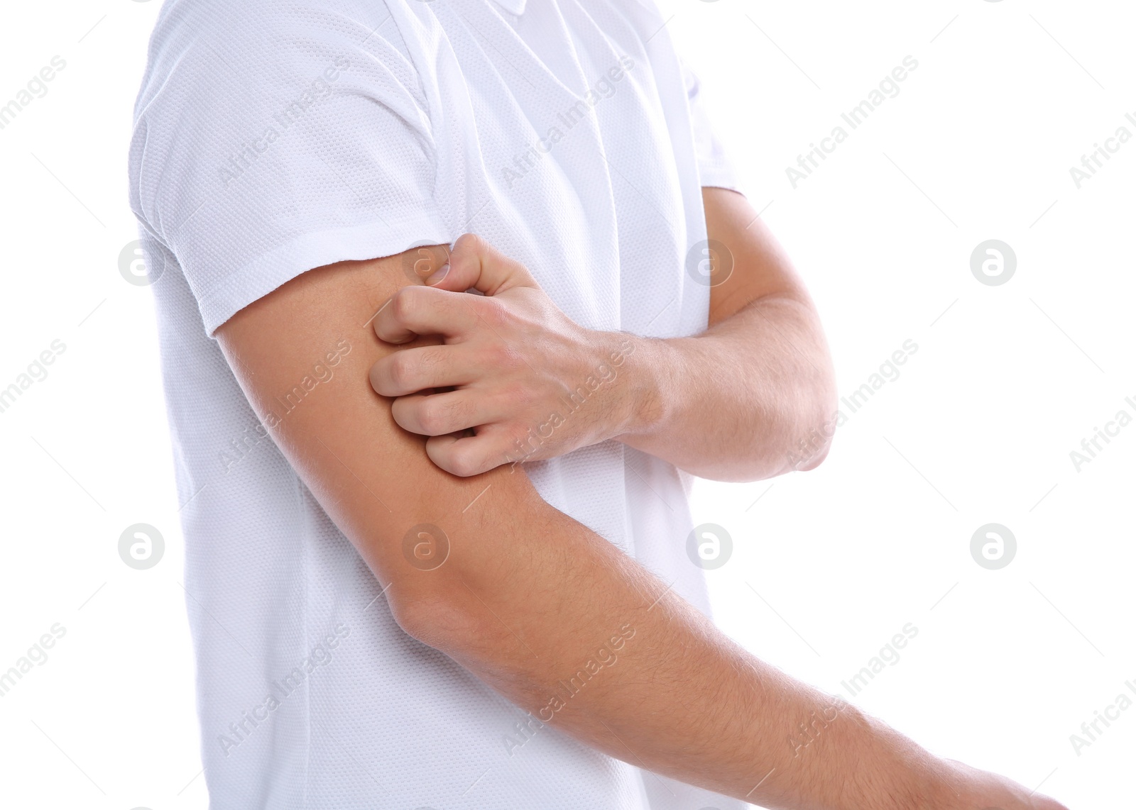 Photo of Young man scratching arm on white background, closeup. Annoying itch