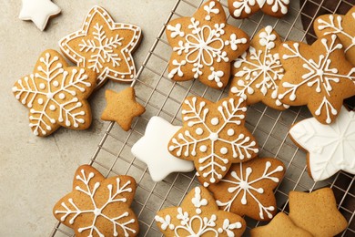 Tasty Christmas cookies with icing on light table, flat lay