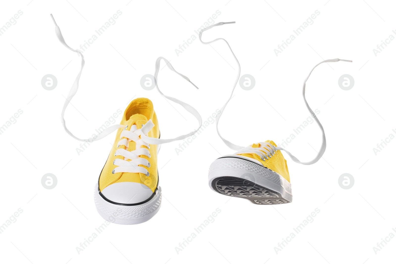 Photo of Pair of yellow classic old school sneakers on white background