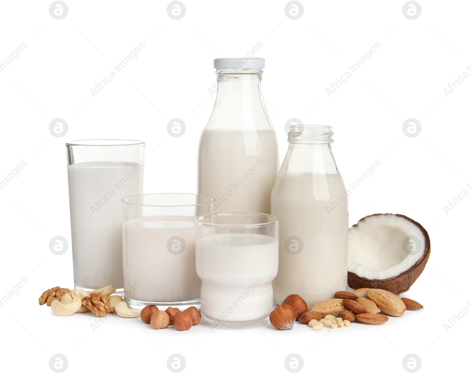 Photo of Vegan milk and different nuts on white background