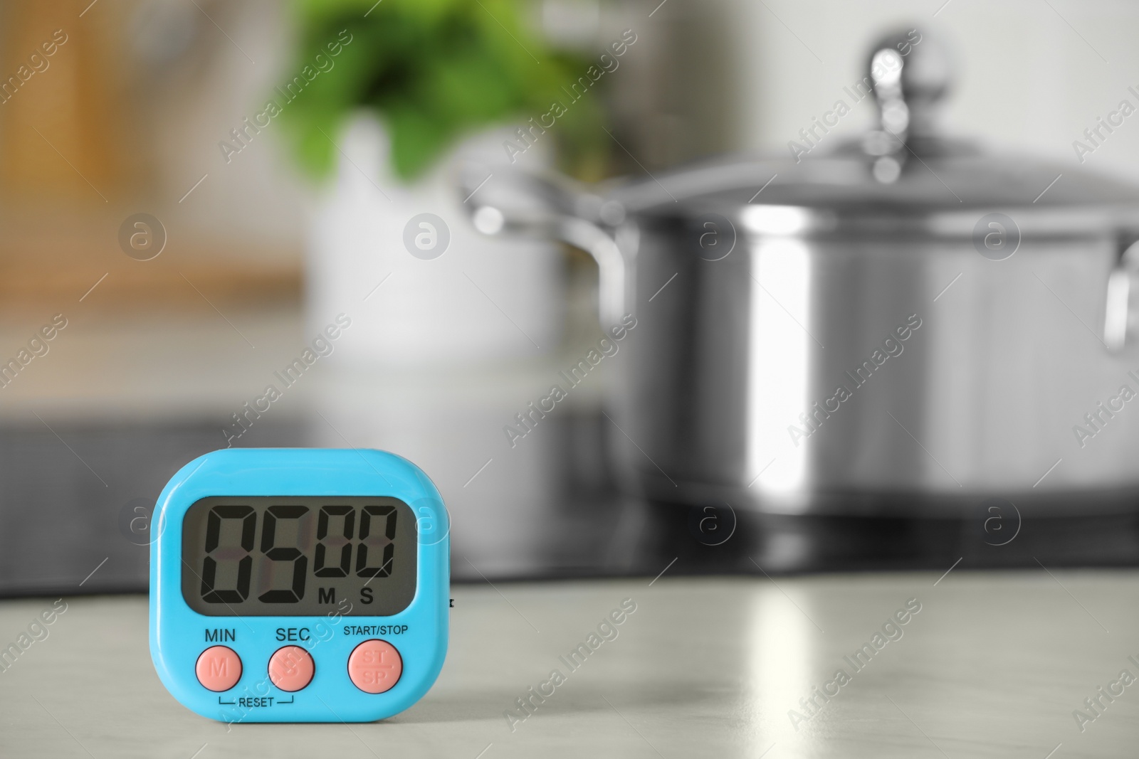 Photo of Digital kitchen timer on white table indoors. Space for text