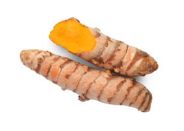 Photo of Fresh whole and cut turmeric roots isolated on white, top view
