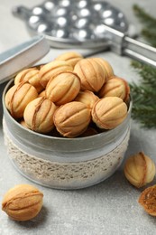Delicious nut shaped cookies with boiled condensed milk on light grey table