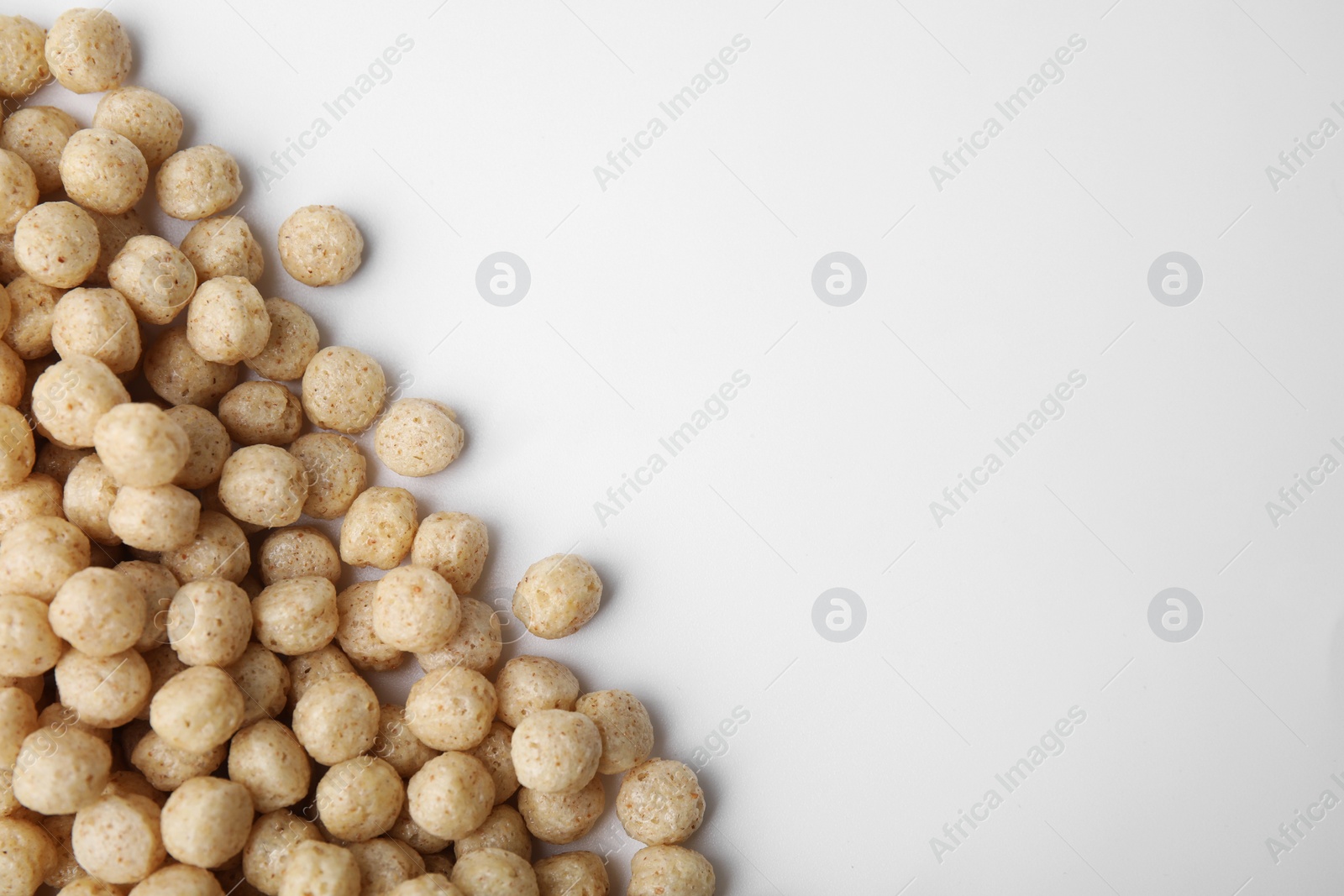 Photo of Tasty cereal balls on white background, flat lay