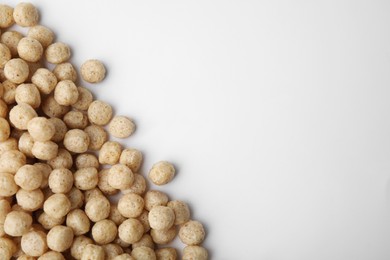 Photo of Tasty cereal balls on white background, flat lay