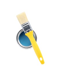 Photo of Can of light blue paint with brush isolated on white, top view