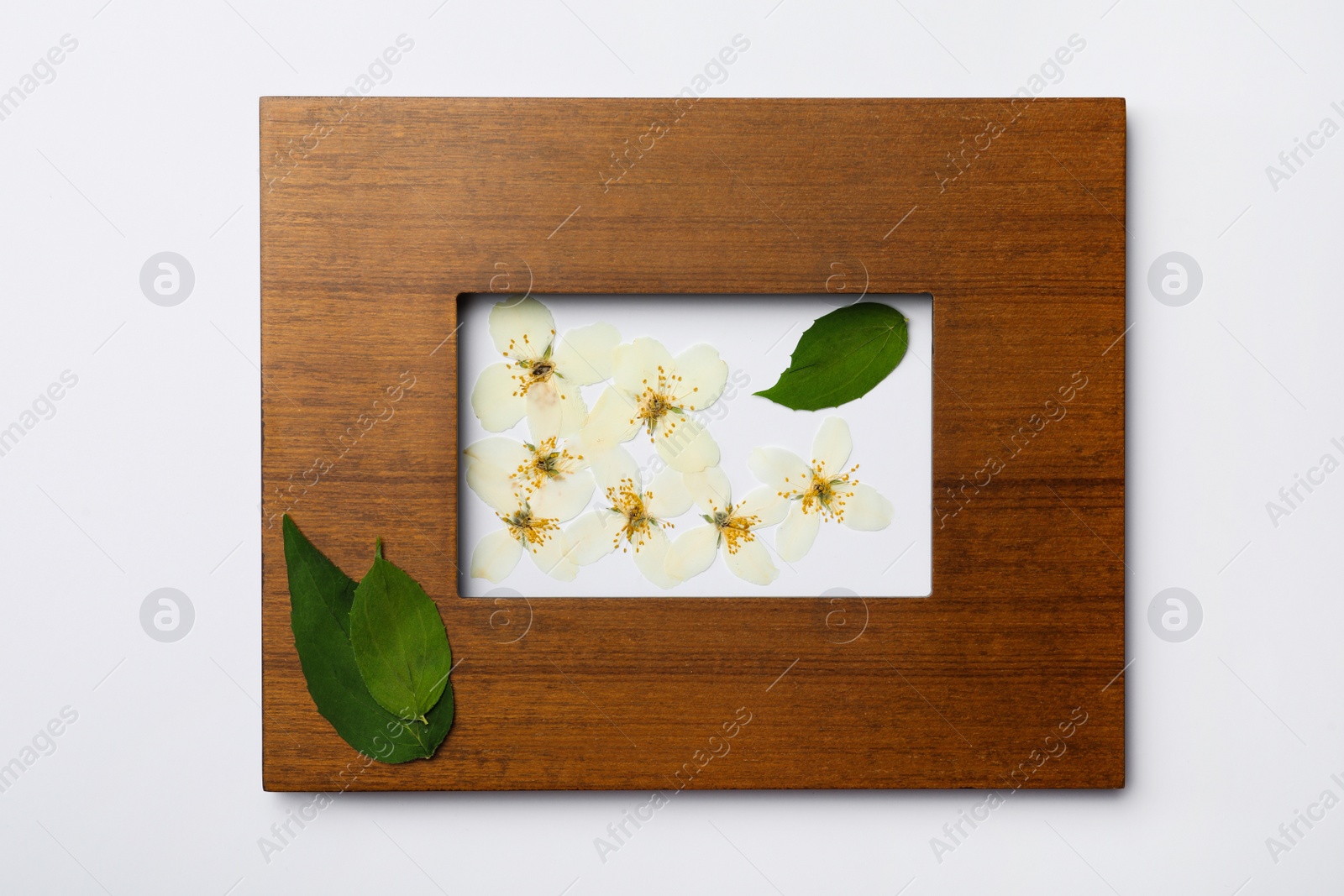 Photo of Frame with wild dried meadow flowers on white background, top view