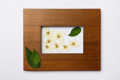 Photo of Frame with wild dried meadow flowers on white background, top view