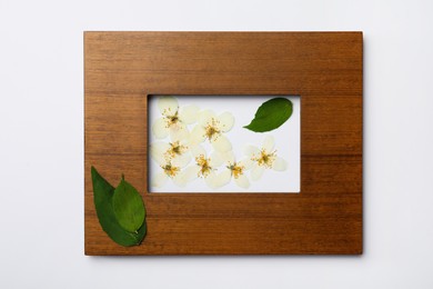 Frame with wild dried meadow flowers on white background, top view