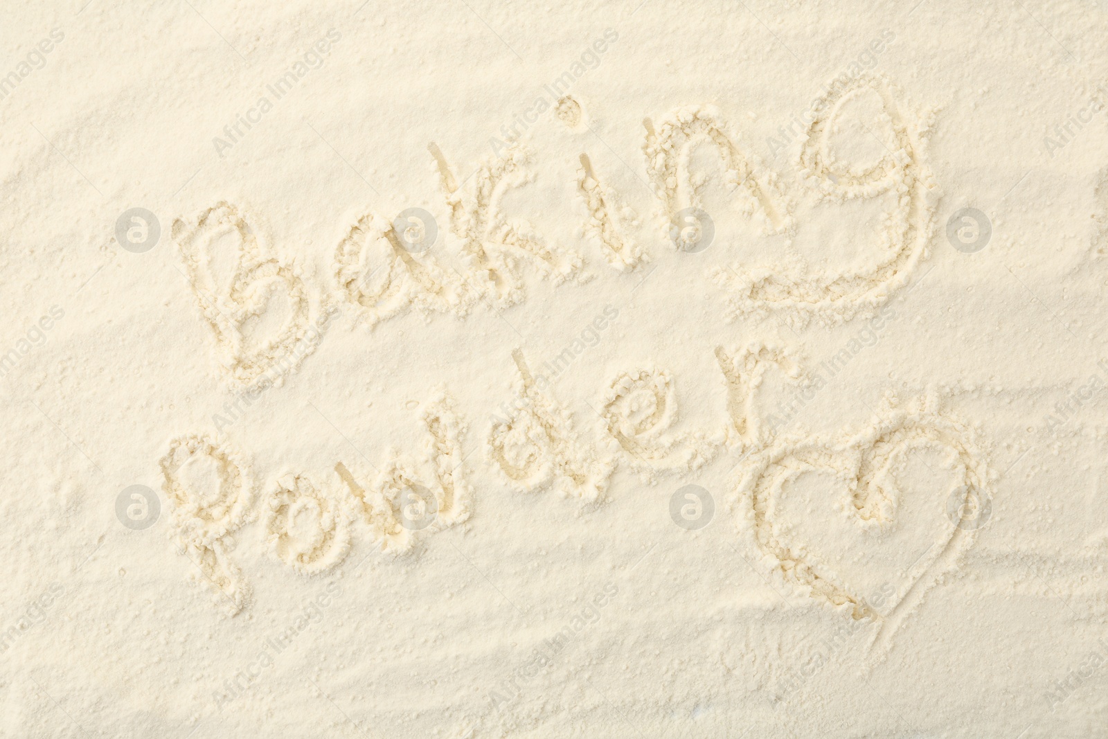 Photo of Words Baking Powder and heart written on powder, top view