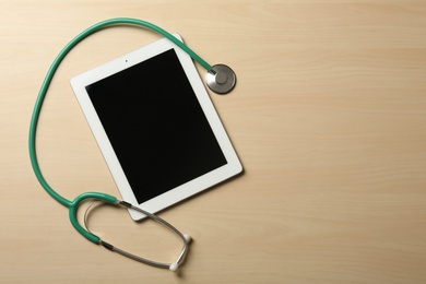 Photo of Stethoscope, tablet and space for text on table. Medical students stuff