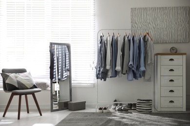 Dressing room interior with clothing rack and mirror