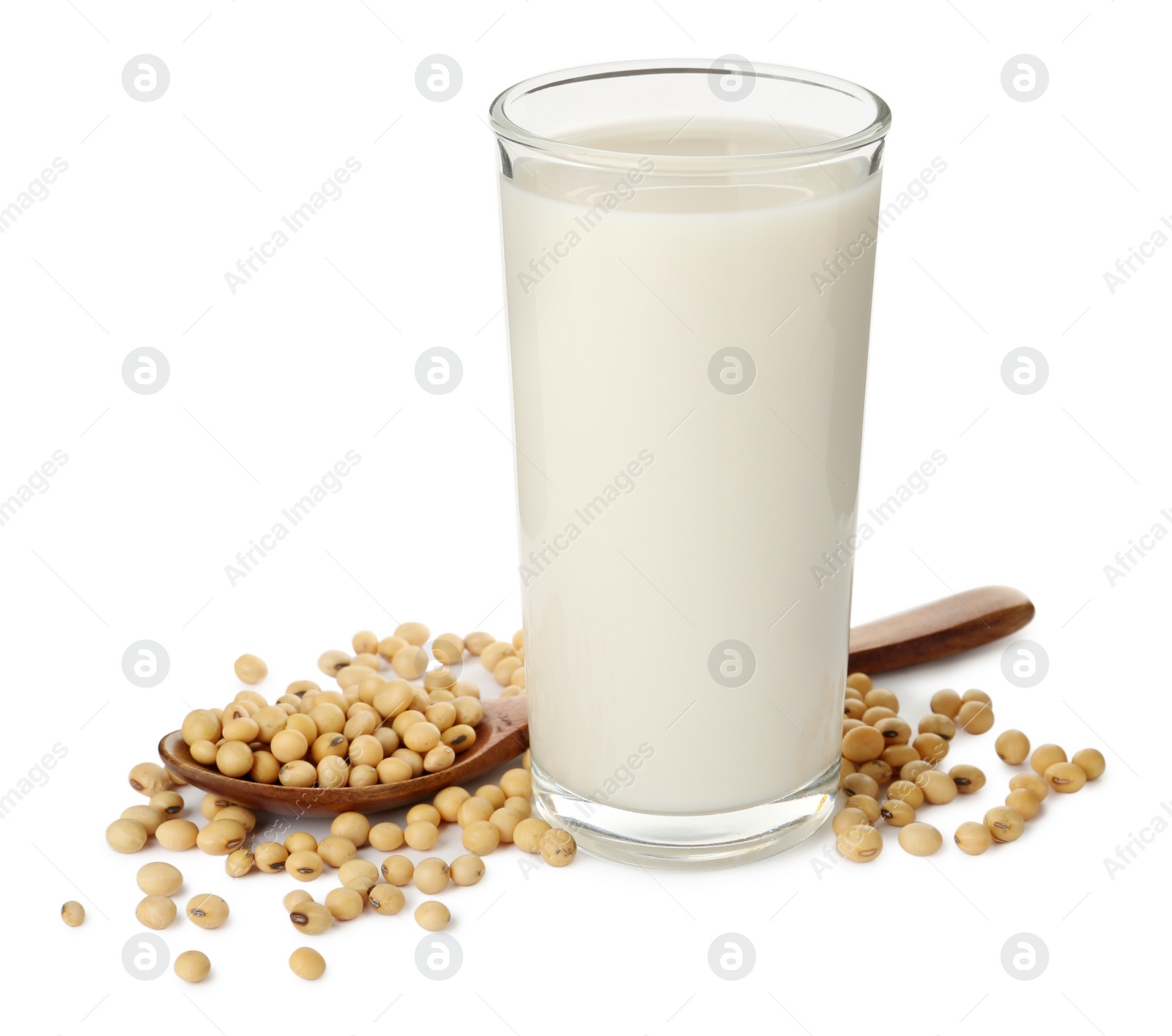 Photo of Glass of fresh soy milk and spoon with beans on white background