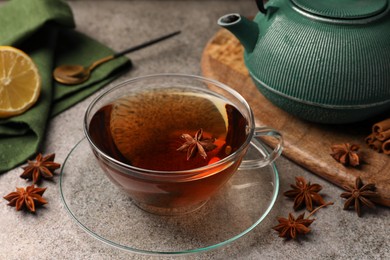 Aromatic tea with anise stars on light grey table