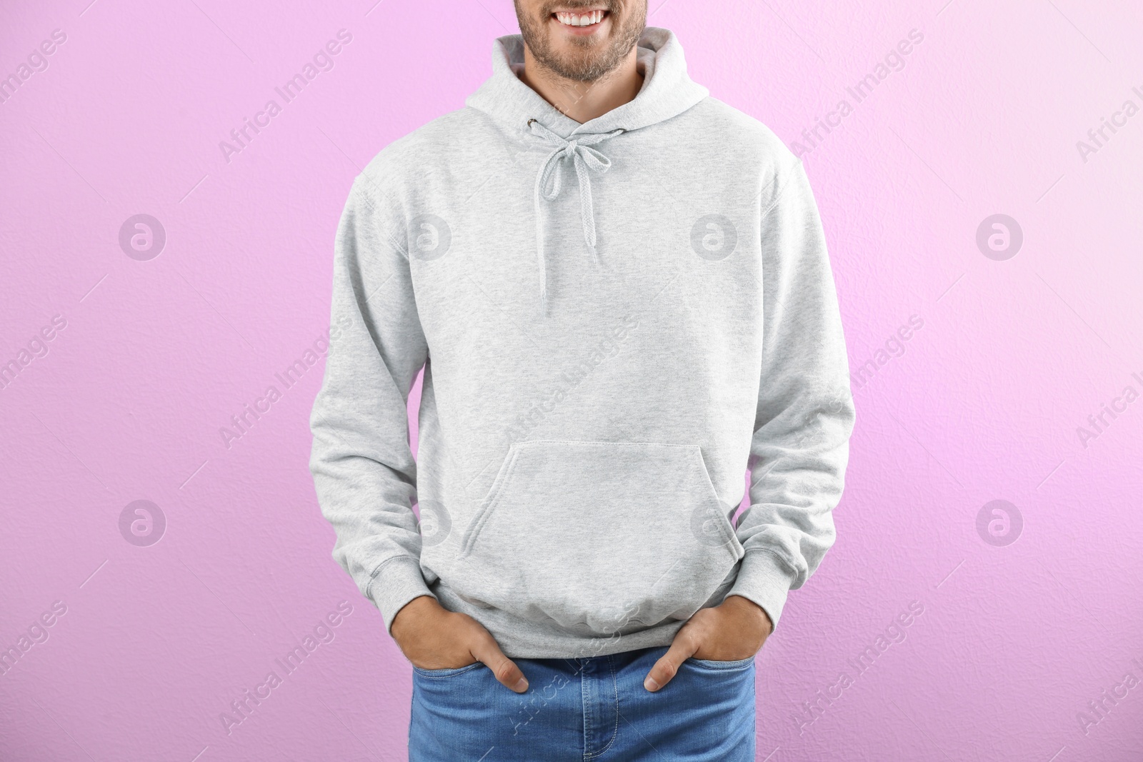 Photo of Man in hoodie sweater on color background. Space for design