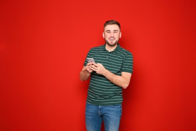 Photo of Portrait of man with mobile phone against color background. Space for text