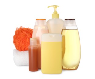 Photo of Many different shower gel bottles, bast wisp and towel on white background