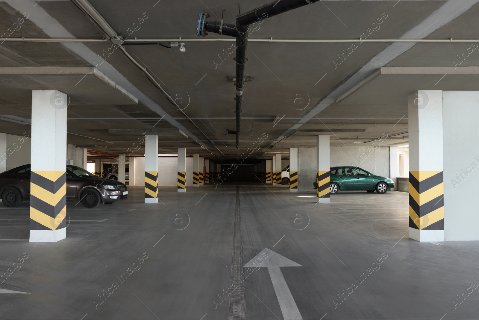 Photo of Open parking garage with cars and empty slots