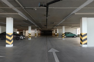 Photo of Open parking garage with cars and empty slots