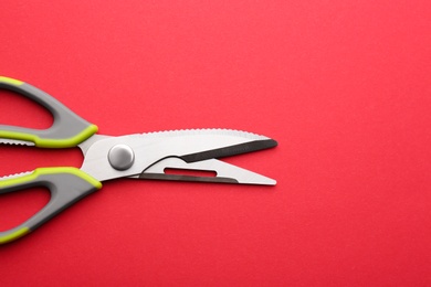 Photo of Kitchen scissors on color background, top view. Space for text