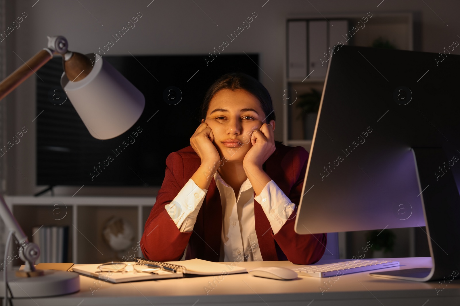 Photo of Tired overworked businesswoman at table in office