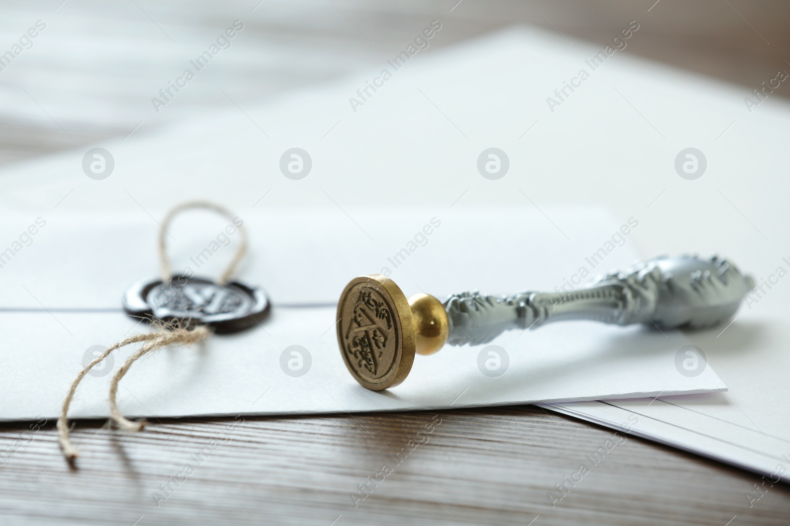 Photo of Vintage notary stamp and documents on wooden table, closeup. Space for text