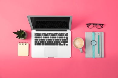 Photo of Flat lay composition with laptop and office tools on pink background