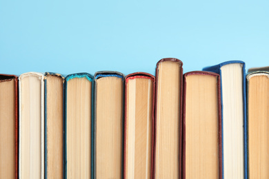 Photo of Collection of old books on light blue background