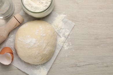 Photo of Cooking scones with soda water. Dough and ingredients on white wooden table, flat lay. Space for text