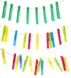 Colorful plastic clothespins hanging on ropes against white background