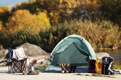 Photo of Set of equipment near camping tent outdoors