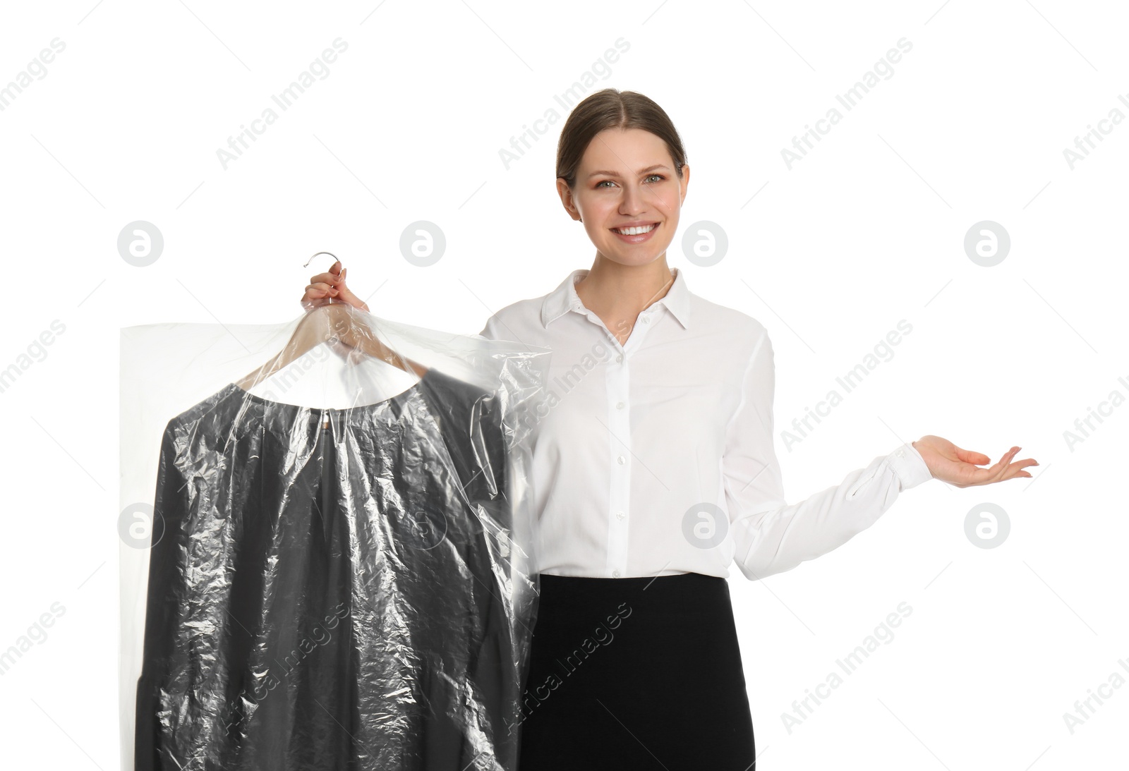 Photo of Young woman holding hanger with dress in plastic bag on white background. Dry-cleaning service