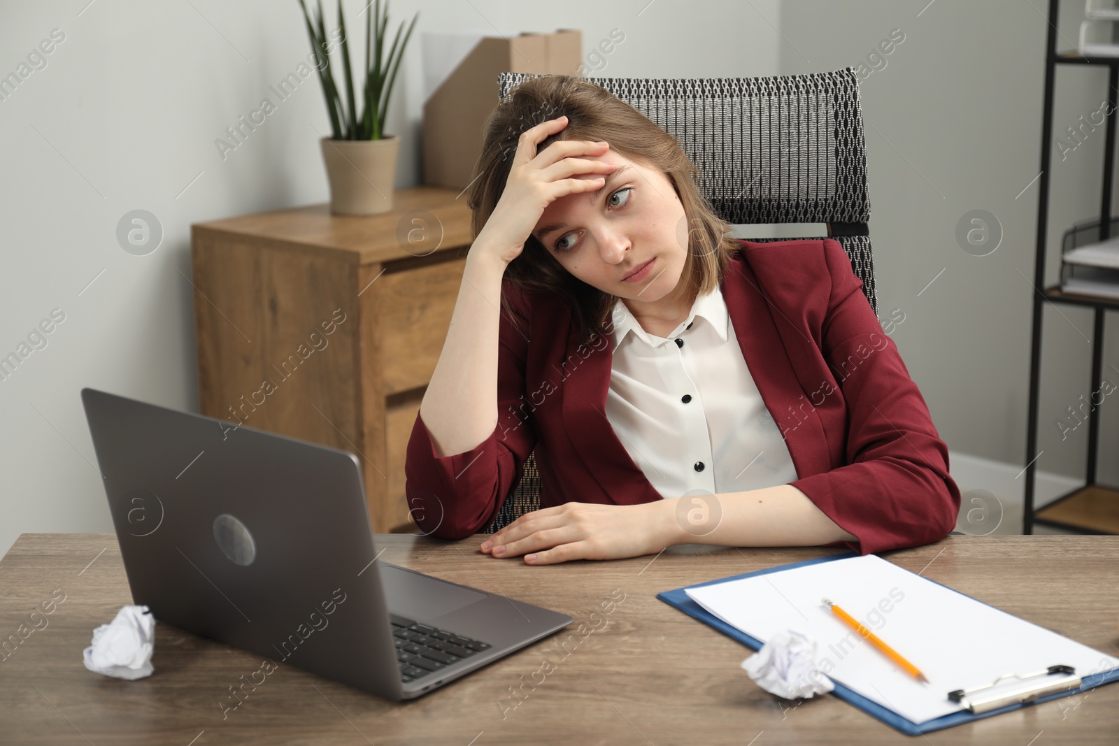 Photo of Sad businesswoman working at wooden table in office