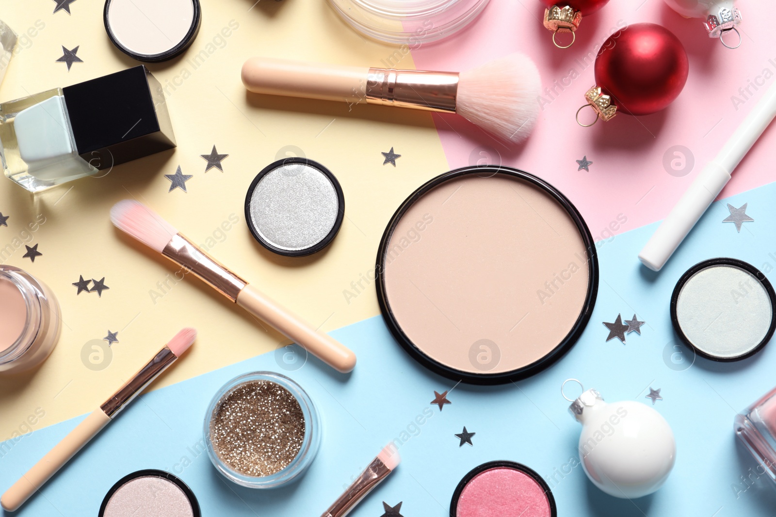 Photo of Flat lay composition with makeup products and Christmas decor on color background