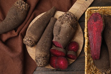 Whole and cut red beets on table, flat lay