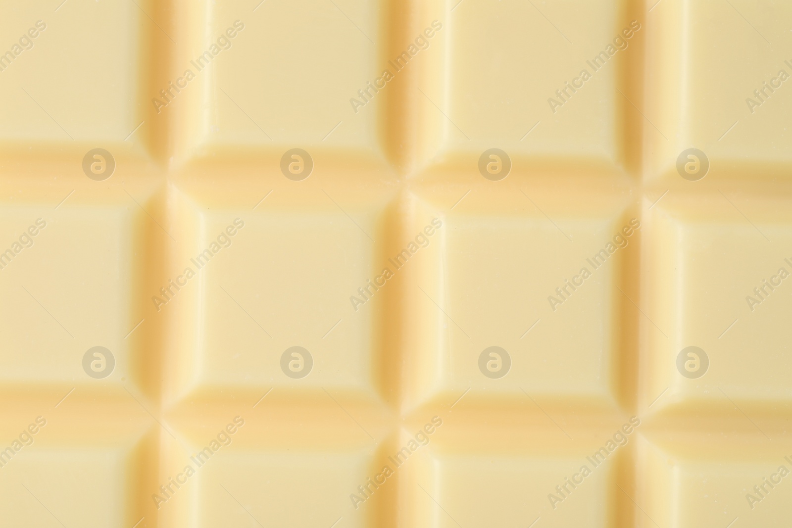 Photo of Delicious white chocolate as background, closeup view